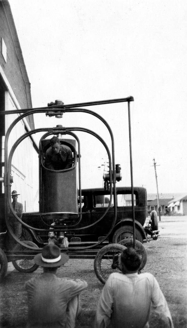 A rear-angle view of the early mechanical flight simulator, highlighting its multi-axis gimbal rings.