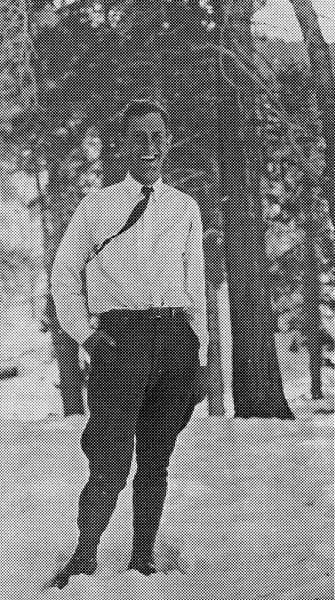 A halftone print image of a smiling Donald A. Hall Sr. standing in the snow wearing a white shirt and a dark tie.
