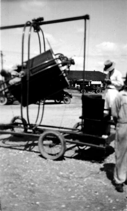 An action shot of the Ruggles Orientator ground simulator pitched sharply backward within its gimbal rings, operated by an instructor.