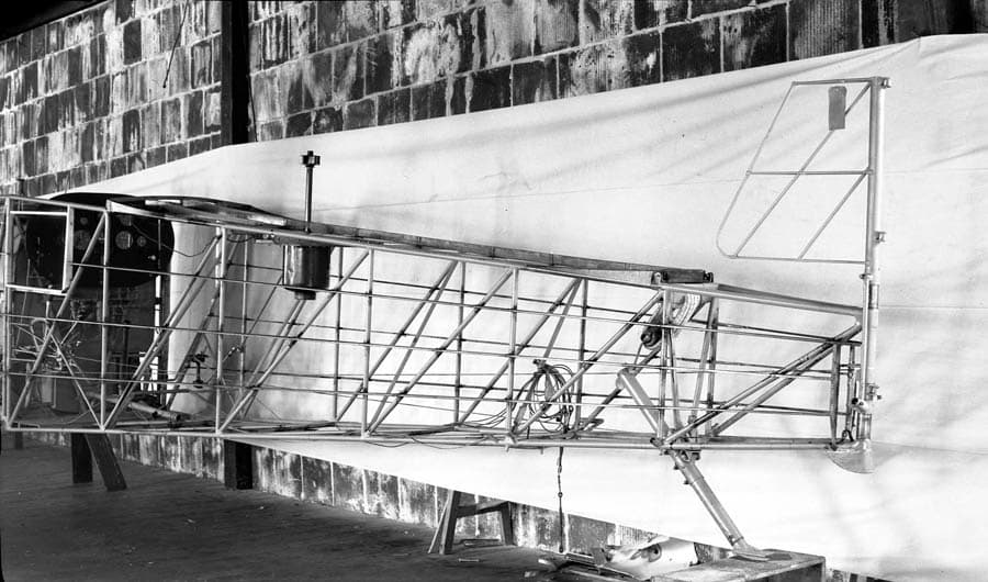 The bare tubular steel framework of the aft fuselage and tail section of the Spirit of St. Louis, showing the internal bracing wires.