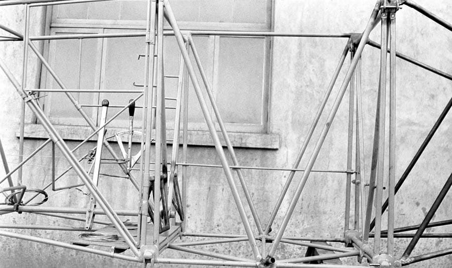 A closer view of the raw tubular steel fuselage framework, focusing on the cockpit area and control stick placement.