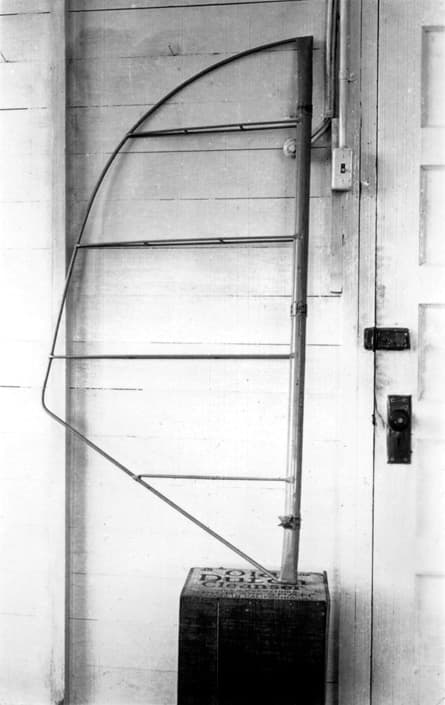 A close-up view of the bare tubular steel framework of the Spirit of St. Louis elevator, resting on a wooden box.