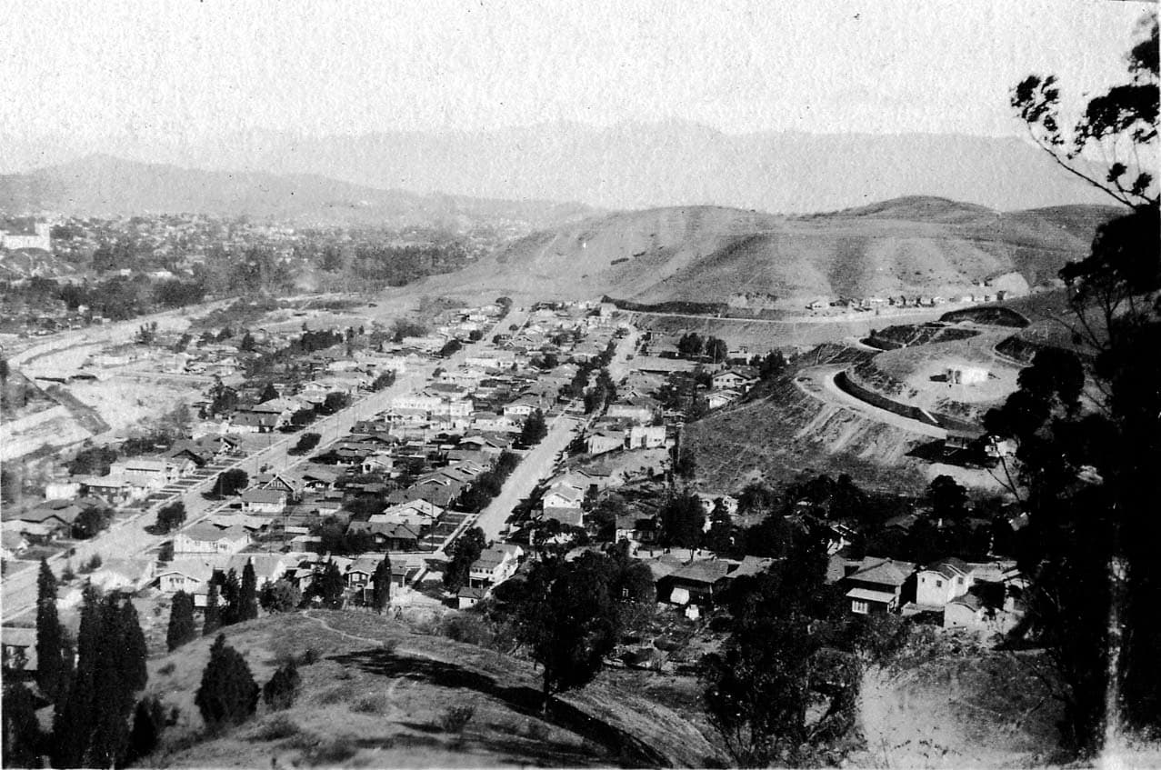 An expansive landscape view overlooking the rolling hills, houses, and infrastructure on the outskirts of Los Angeles County.