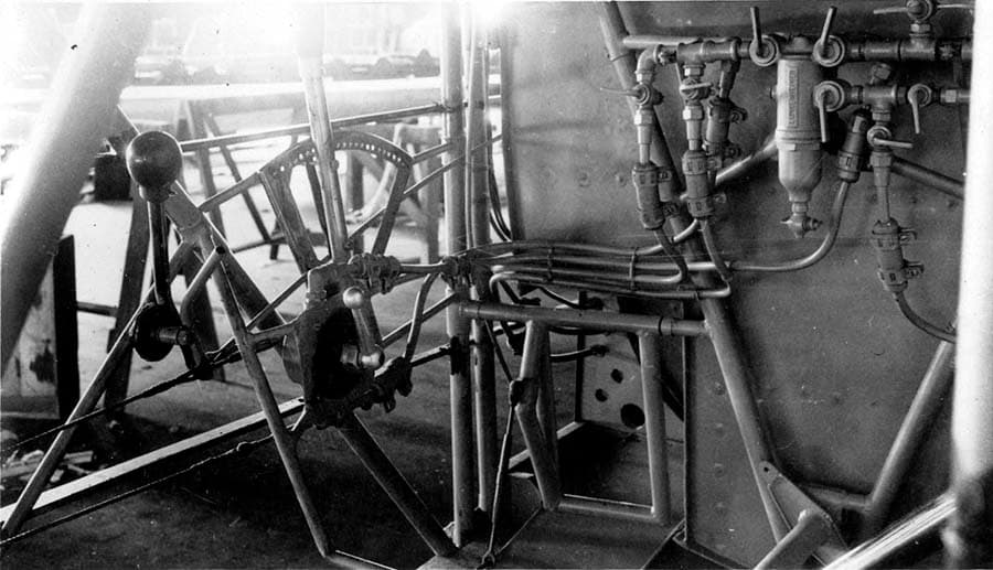 Cockpit interior photograph showing manual fuel wobble pump lever, throttle quadrant, and selector valves.