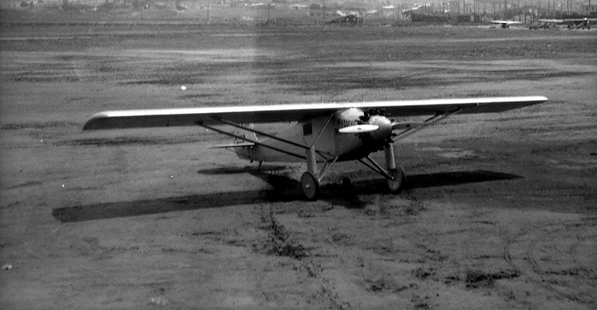 Elevated view looking down at the front-right three-quarter profile of the Spirit of St. Louis on Dutch Flats.