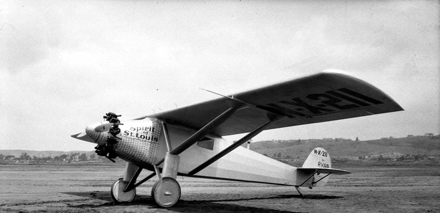 Angled low-perspective photograph showing the underside of the Spirit of St. Louis left wing and engine cowl.