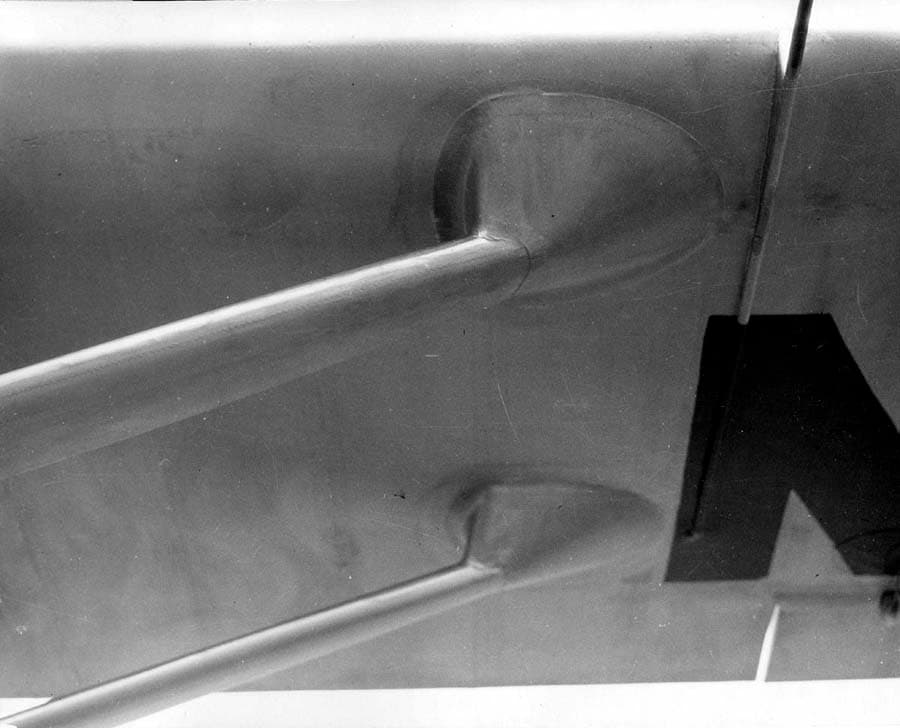 Macro photograph of streamlined wing strut attachment fairings under the wing showing edge of painted registration.