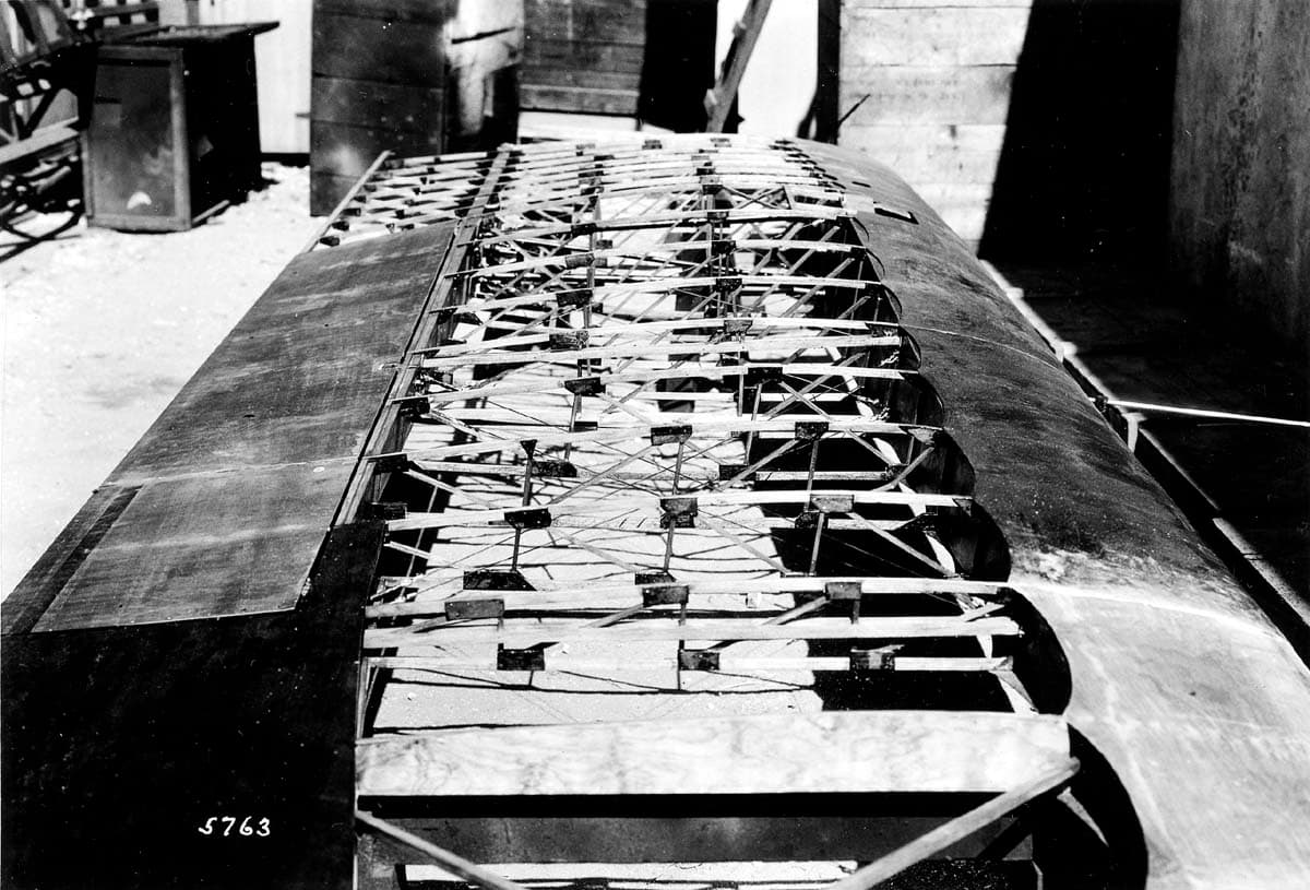 Workshop photograph plate 5763 showing the unfinished wooden wing structure of the Hall X-1 monoplane on sawhorses.