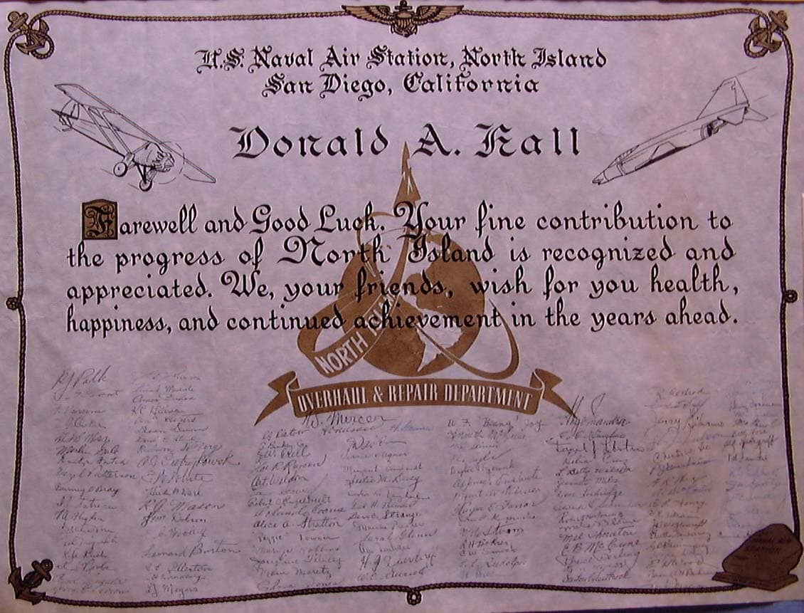An illuminated calligraphic testimonial scroll from NAS North Island Overhaul and Repair Department hand-signed by fifty colleagues.