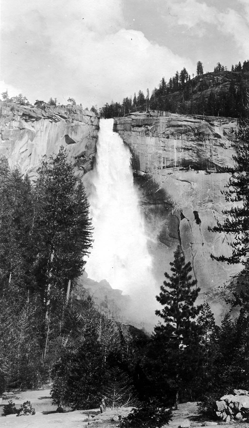 The roaring cascade of Nevada Fall plunging over its distinctive sloping granite apron beneath high alpine cliffs on the Merced River.