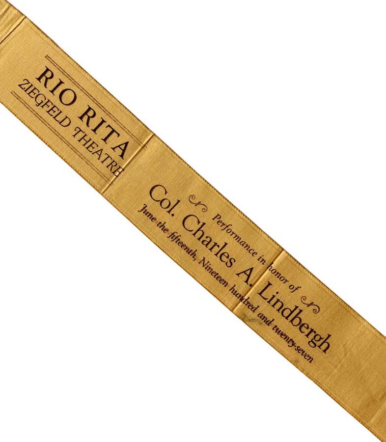 Gold silk ribbon from the Ziegfeld Theatre gala performance of Rio Rita in honor of Colonel Charles A. Lindbergh on June 15, 1927.