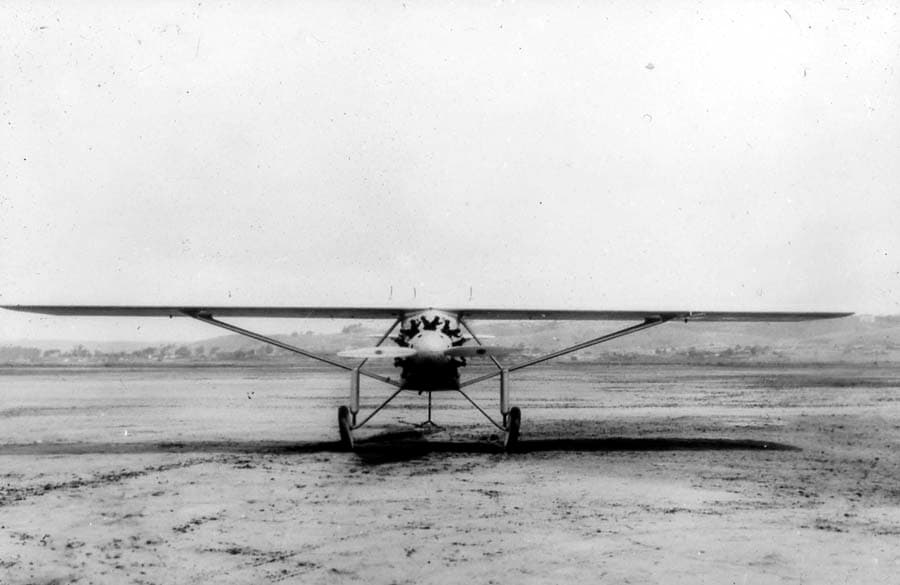 Frontal head-on view of the Spirit of St. Louis on Dutch Flats field with tail elevated on a stand during center-of-gravity testing.