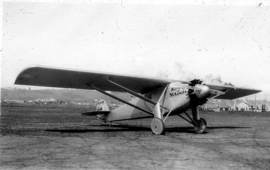 Three-quarter front view of the finished Spirit of St. Louis at Dutch Flats showing damascened nose cowl and wing lettering.