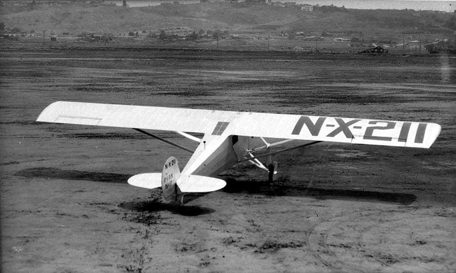 Elevated rear-right three-quarter view showing upper wing surface with large N-X-211 registration and skylight window.
