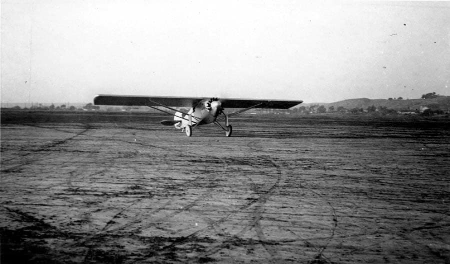 Ground-level airfield photograph showing the Spirit of St. Louis head-on during first flight trials at Dutch Flats.
