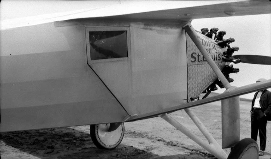 Close-up flightline view of the left forward fuselage showing damascened nose cowl, periscope housing, and cockpit door.