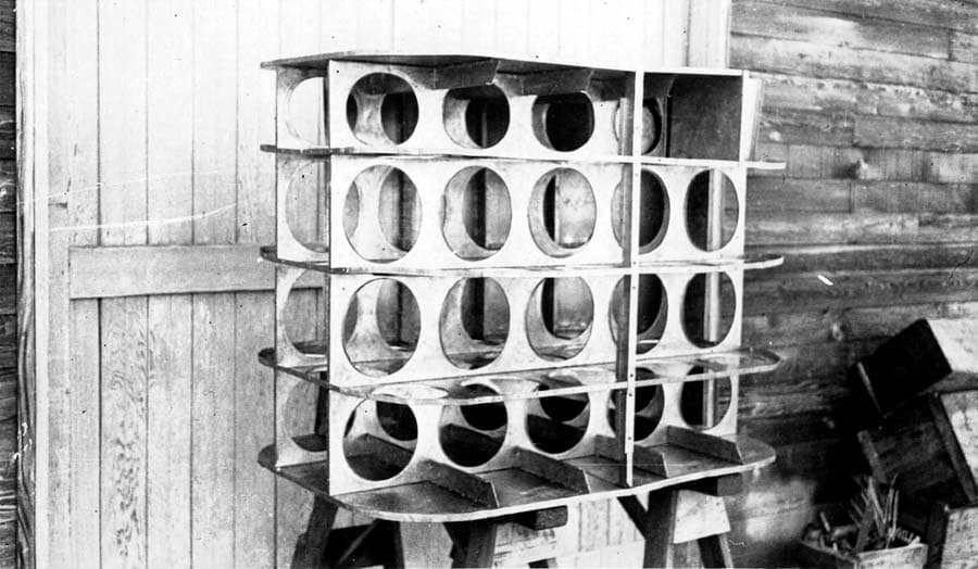 Angled perspective of internal fuel tank baffle skeleton on sawhorses showing compartmentalized cells.