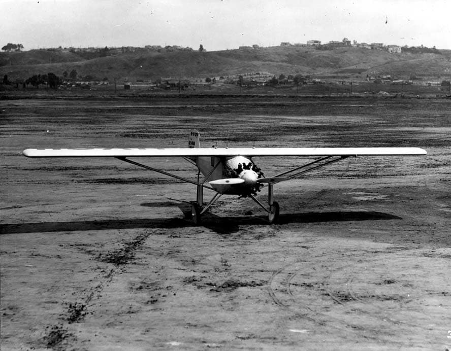 Head-on low-angle photograph of the Spirit of St. Louis parked level on Dutch Flats dirt apron.