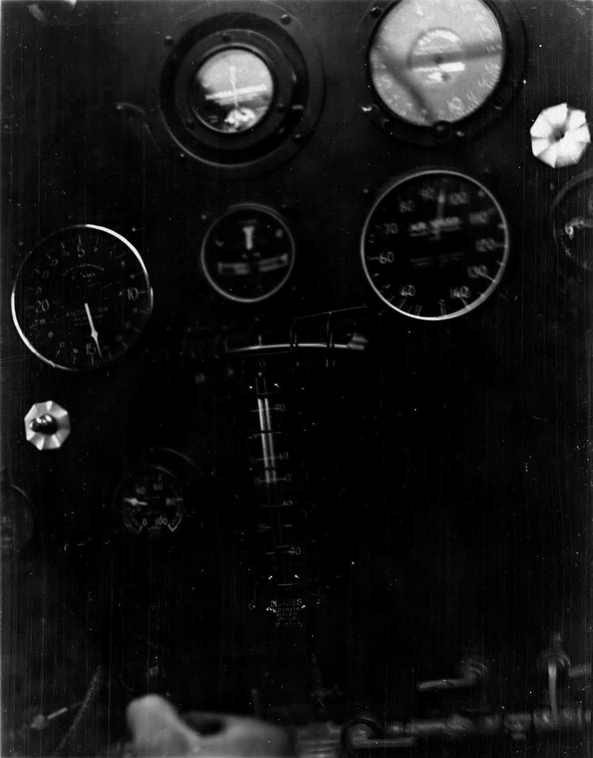 In-flight cockpit panel photograph showing flight instruments and throttle controls during cruise testing.