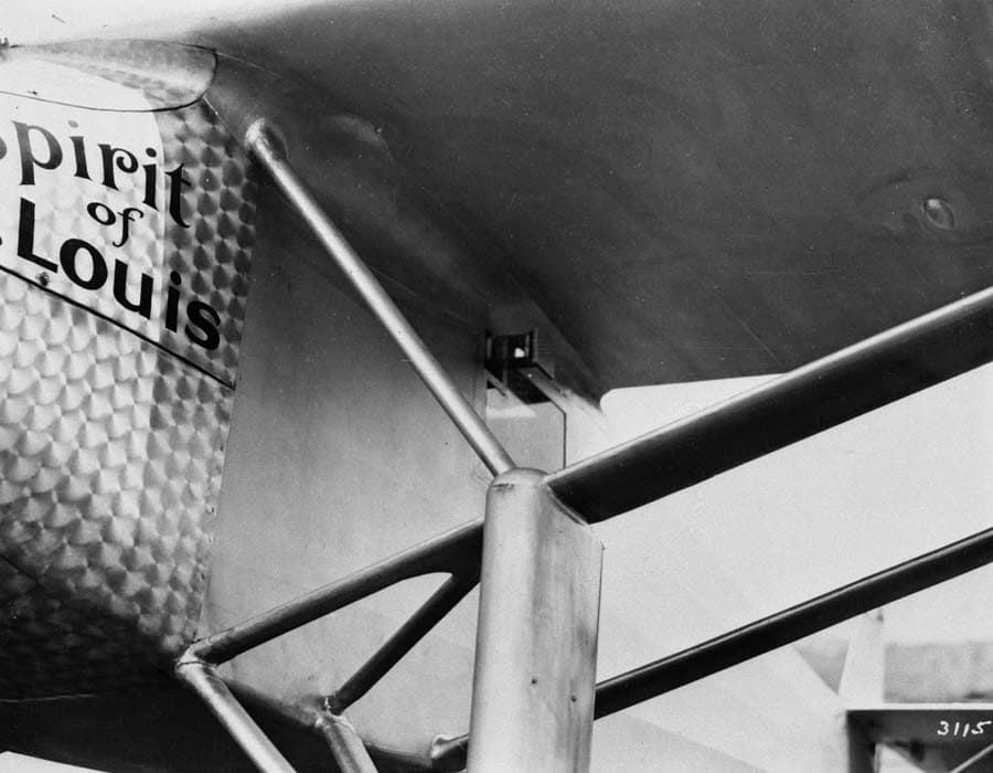Close-up photograph plate 3115 of the exterior periscope housing and prism aperture beneath the wing root on the left fuselage.