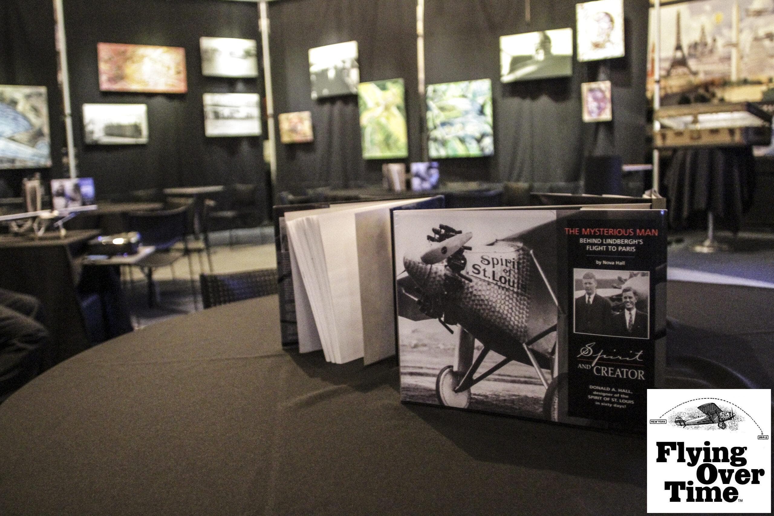 Copies of Spirit & Creator displayed with Flying Over Time exhibition materials