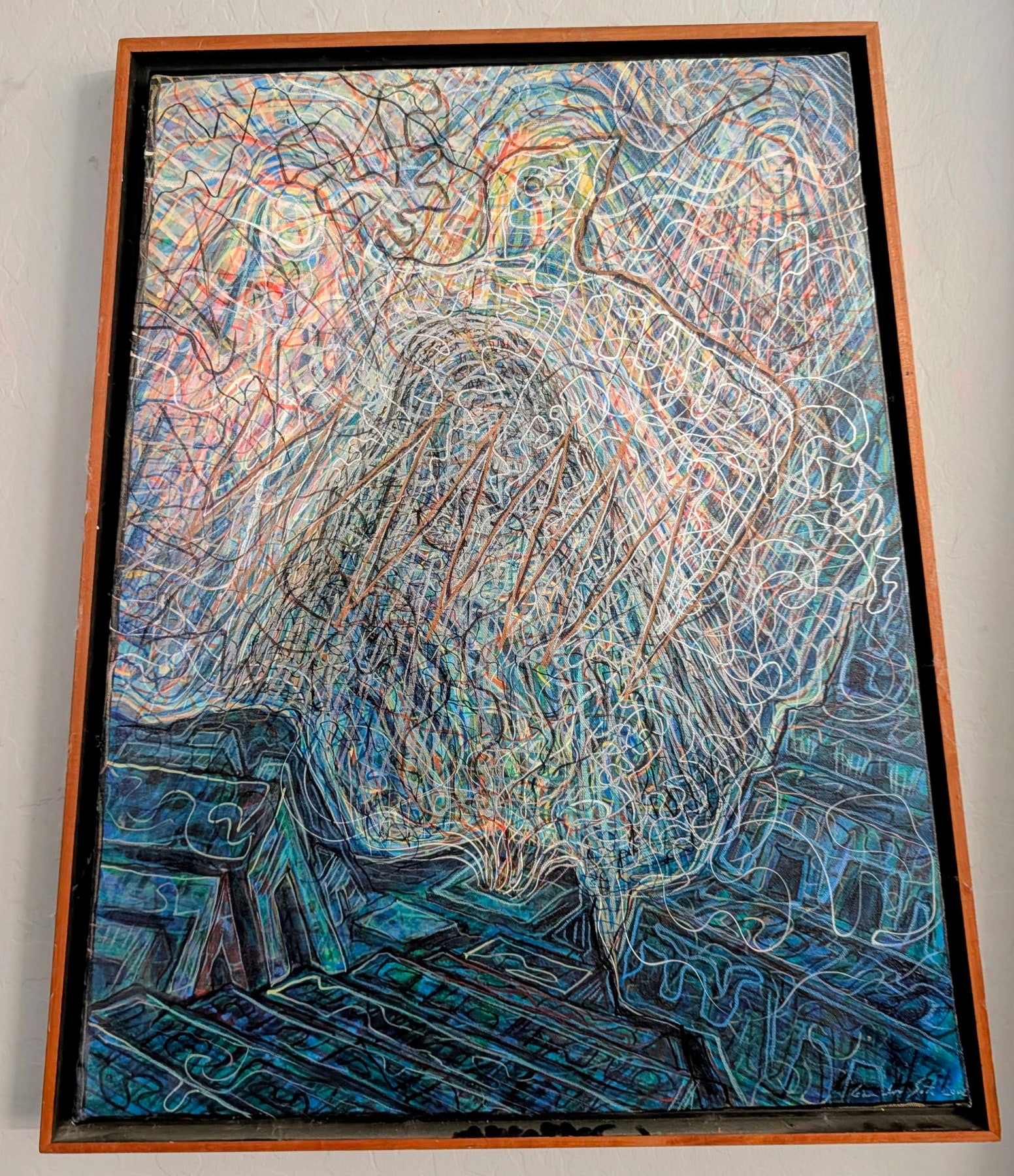 A framed artwork filled with overlapping blue, green, red and white lines and a central human figure.