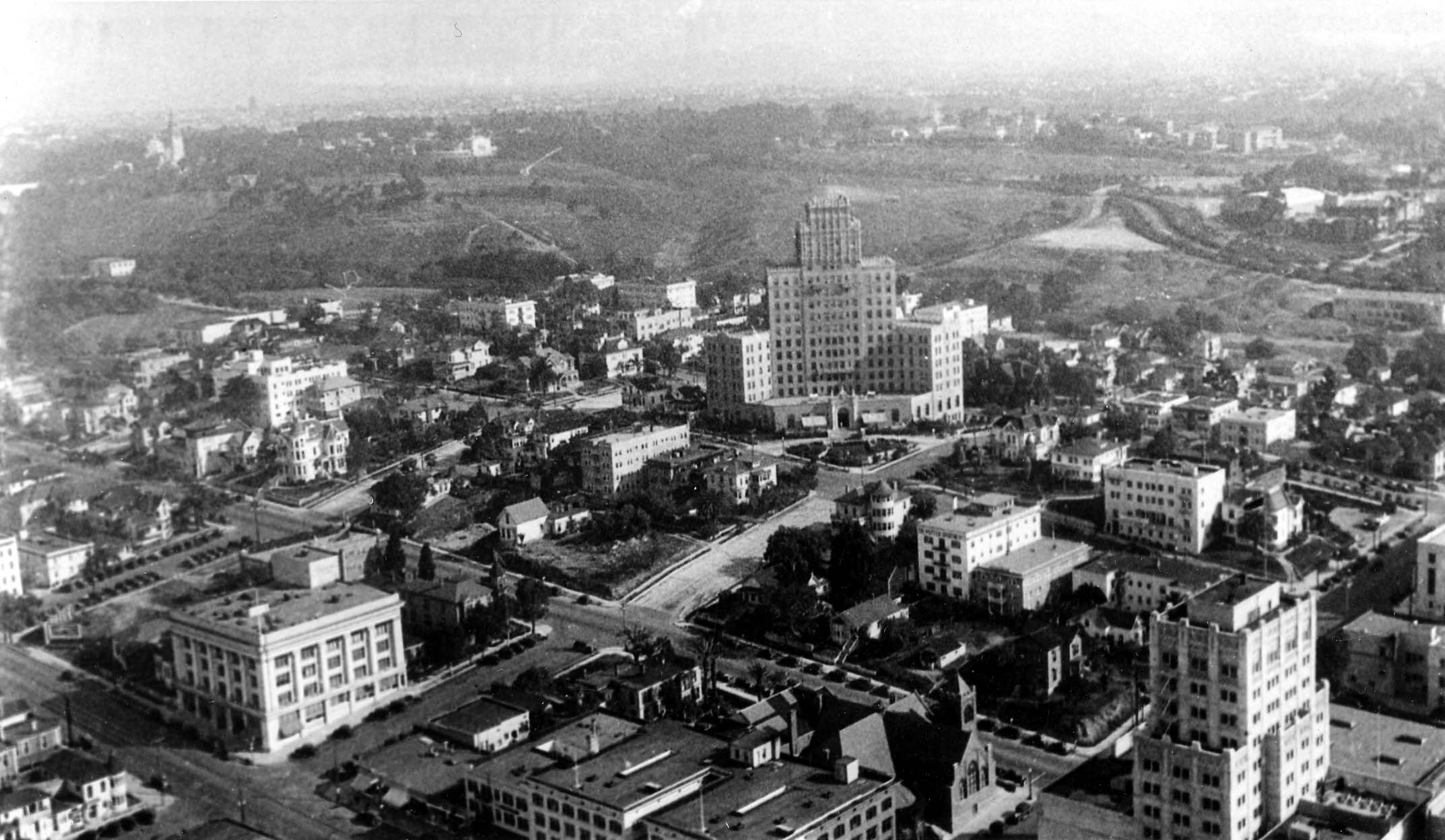 An aerial view of downtown San Diego featuring the newly constructed, towering El Cortez Hotel dominating the skyline.