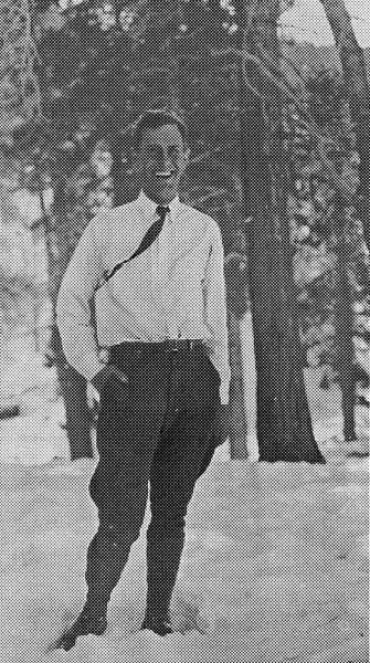 A halftone print image of a smiling Donald A. Hall Sr. standing in the snow wearing a white shirt and a dark tie.