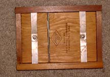 Hardwood instrument case with metal sliding straps stamped with Keuffel and Esser diamond trademark logo.