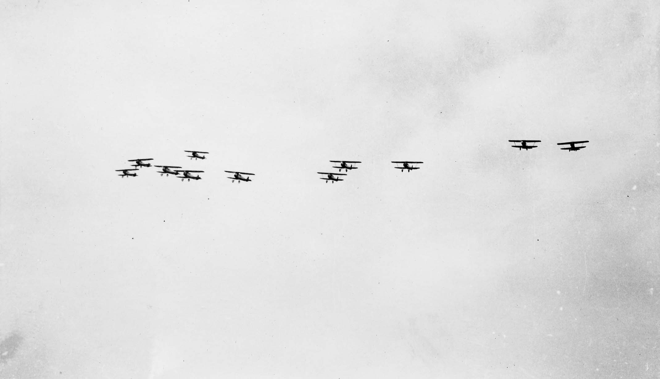 Naval aircraft turning in tight formation in celebration of Charles Lindbergh's successful Transatlantic flight.