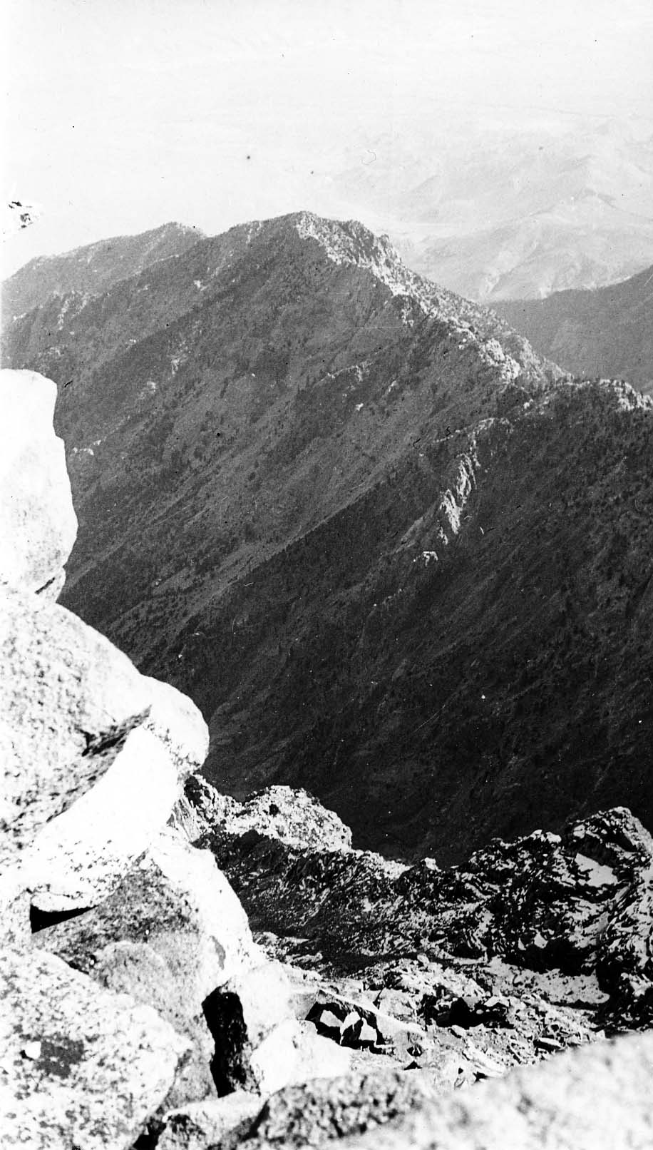 A narrow mountain pass winding between two large rock faces.