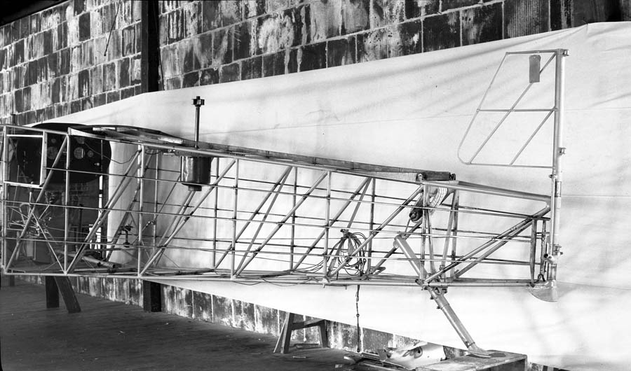 The bare tubular steel framework of the aft fuselage and tail section of the Spirit of St. Louis, showing the internal bracing wires.