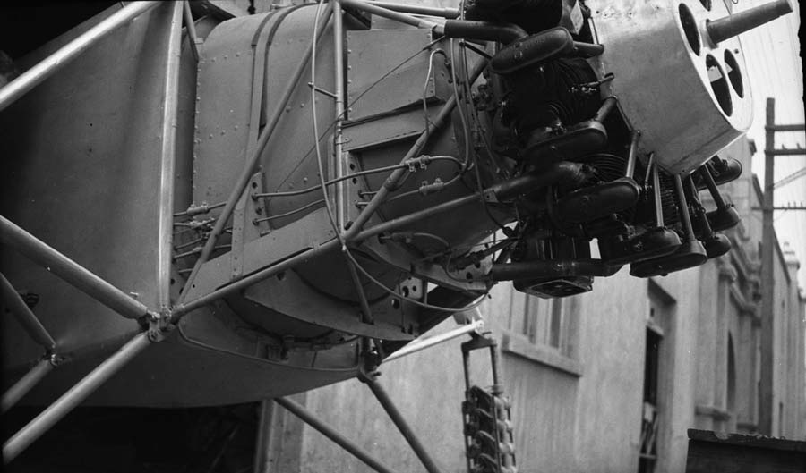 A close-up side profile of the Spirit of St. Louis nose, detailing the Wright Whirlwind engine, the oil tank, and the forward fuel tank.