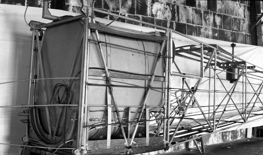 The massive main fuel tank installed within the tubular steel fuselage of the Spirit of St. Louis, showing complex external fuel lines.
