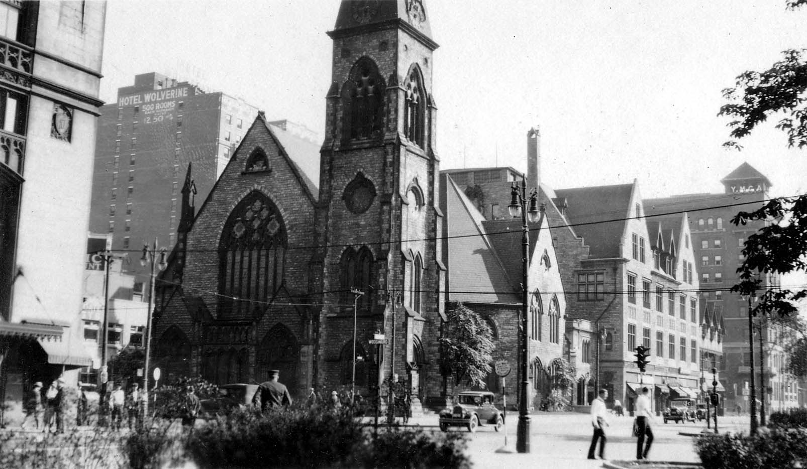 Woodward Avenue in downtown Detroit showing Central Methodist Church, the Hotel Wolverine sign, and the Downtown Detroit YMCA.