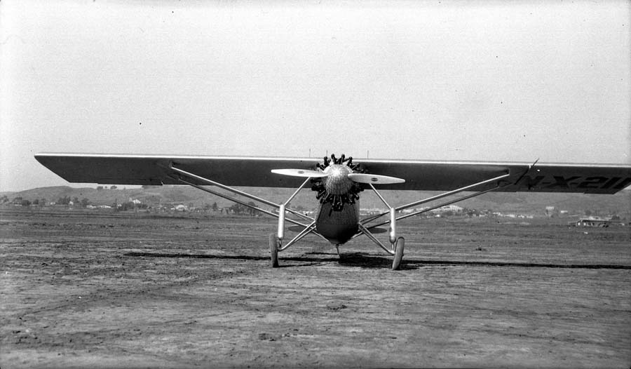Direct head-on photograph of the Spirit of St. Louis on Dutch Flats showing full wingspan and landing gear.