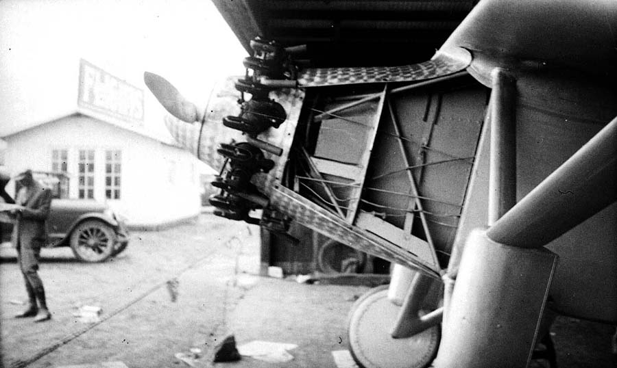 View of the Spirit of St. Louis nose without cowling showing the Wright Whirlwind engine, mount, and airfield car.