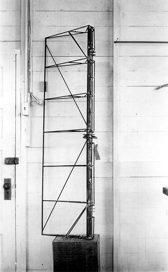 Second vertical engineering view of uncovered welded steel aileron frame showing hinge mounts and torque horn.