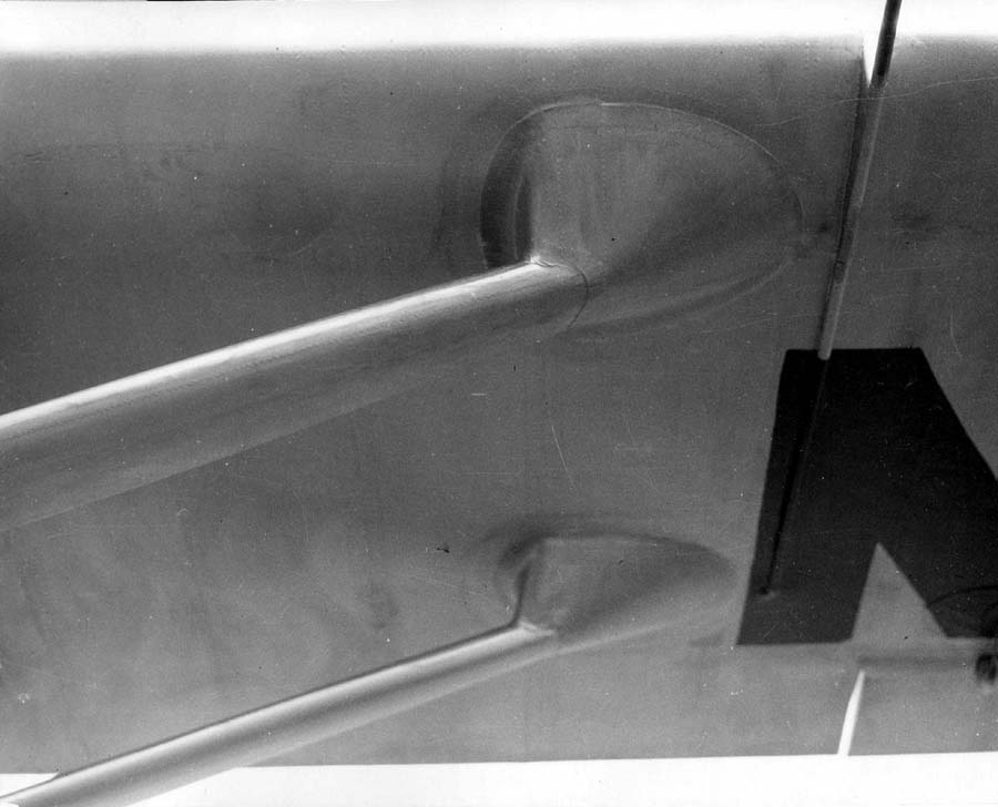 Macro photograph of streamlined wing strut attachment fairings under the wing showing edge of painted registration.