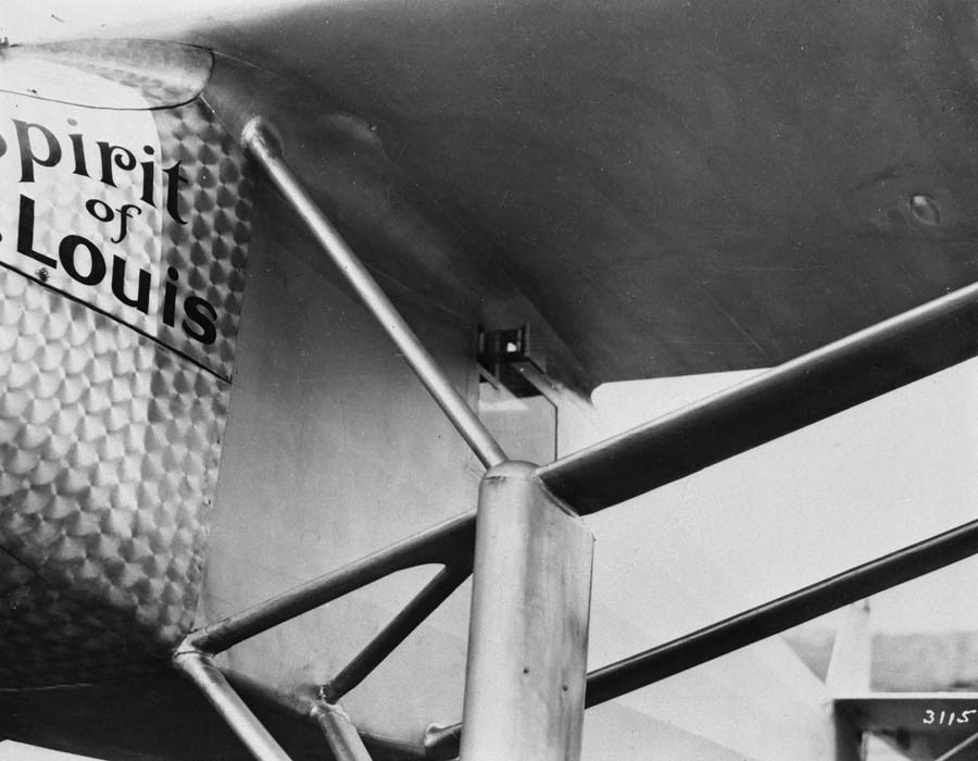 Close-up photograph plate 3115 of the exterior periscope housing and prism aperture beneath the wing root on the left fuselage.