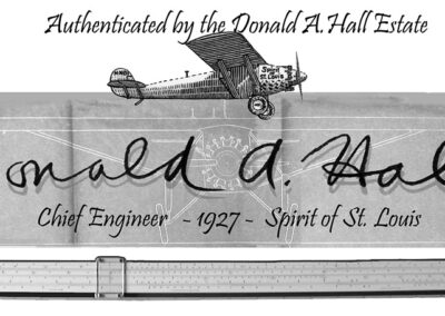Trademark for the Donald A. Hall Estate collection including the signature of the engineer Donald Hall, a blueprint front view of the Spirit of St Louis, and the slide rule that was used to design the airplane in 1927.