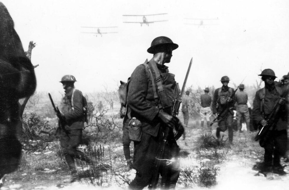 Vintage WWI black and white photograph during training by US Army with Curtiss Jenny biplane aircraft and military soldiers