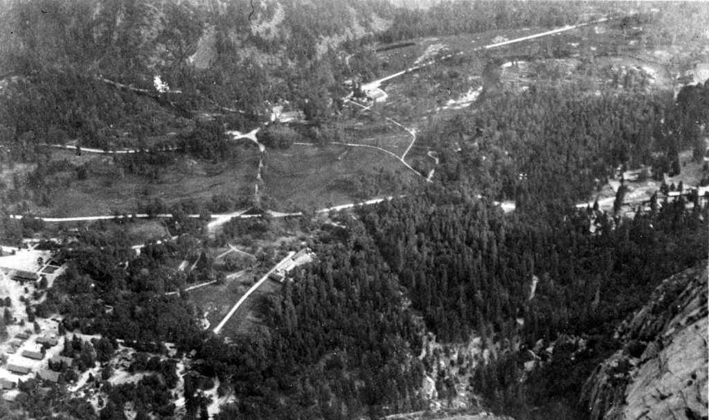 Vintage black and white Photograph showing the valley floor from above including the roads and camp. Taken in California by Donald Hall.