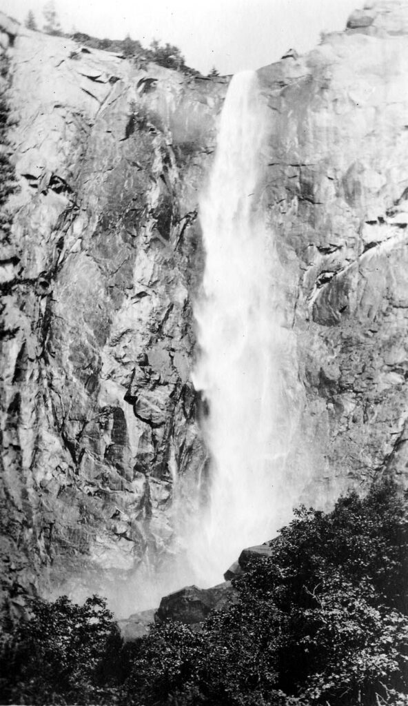 Vintage black and white photograph looking up from the bottom of a waterfall. Taken at Yosemite National Monument, California by Donald Hall.