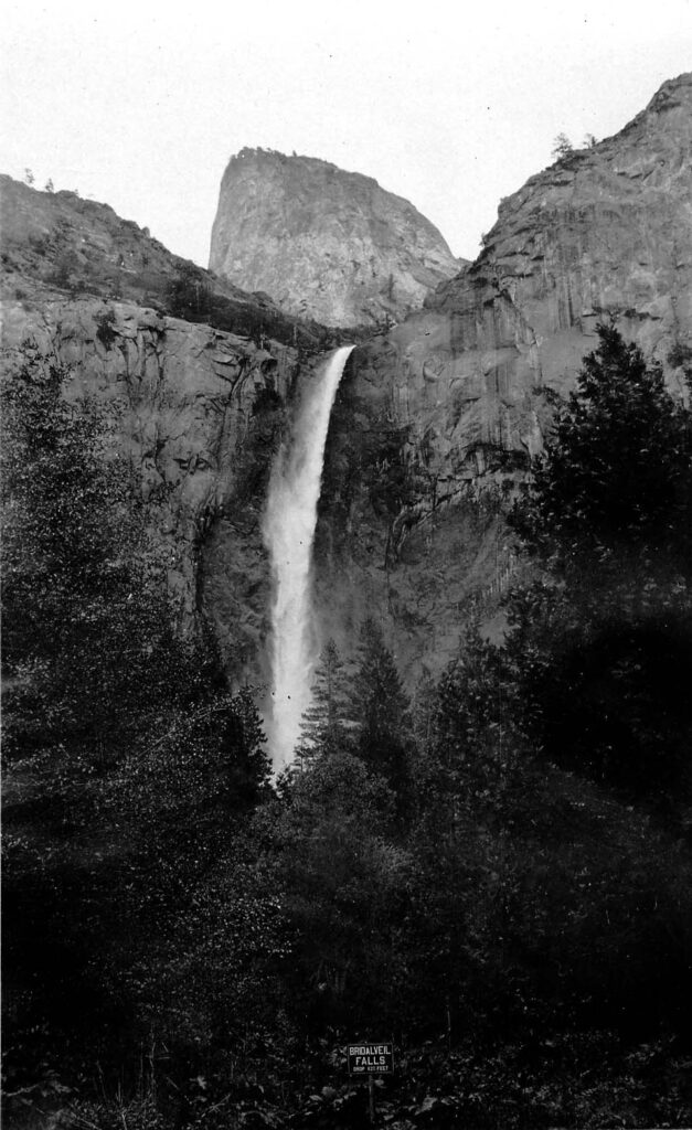 Vintage black and white photograph looking up from the bottom of a waterfall. Taken at Yosemite National Monument, California by Donald Hall.