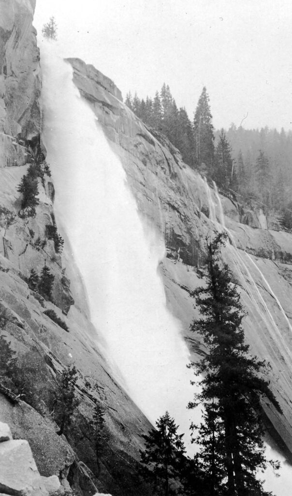 Vintage black and white looking up from the midsection of a waterfall collecting below in a creek. Taken at Yosemite National Monument, California by Donald Hall.