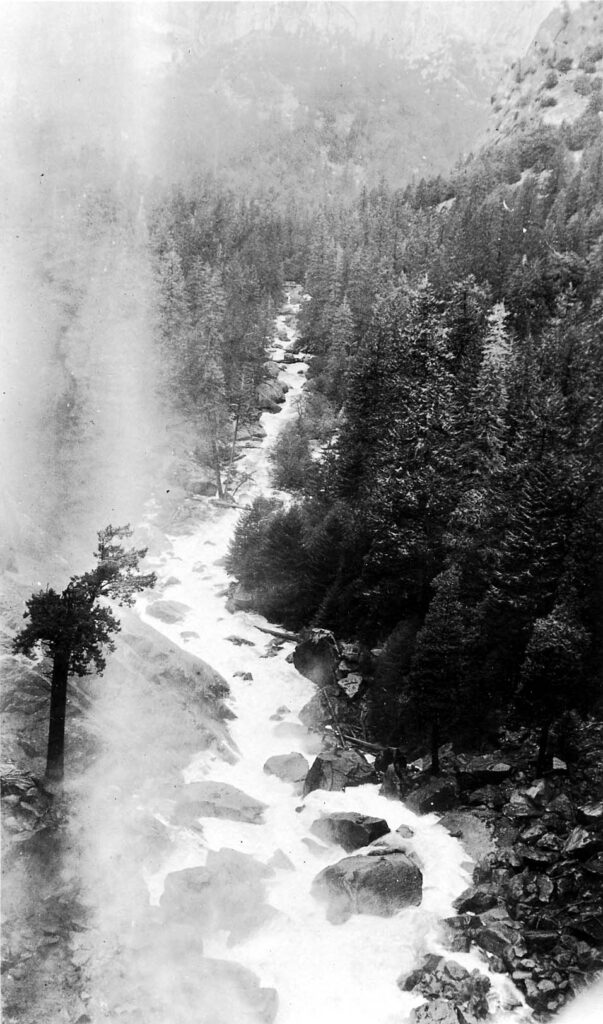 Vintage black and white photograph of the bottom part of an waterfall collecting in a rocky creek. Taken at Yosemite National Monument, California by Donald Hall.