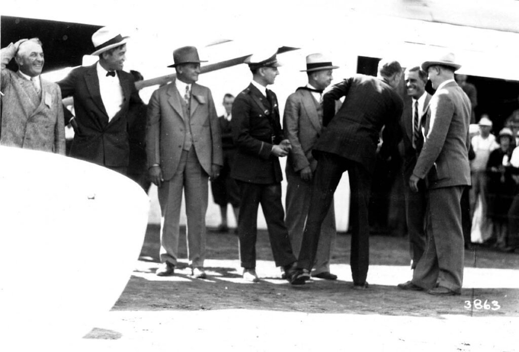 A vintage black and white photograph of pilot Charles Lindbergh shaking Donald A. Hall's hand, designer of the Sprit of St Louis, after his record breaking flight to Paris, France.