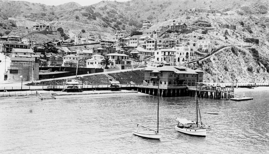 Vintage Black and White photograph of the cove and buildings at Catalina Island from the dock or docked ferry. Photo taken by Donald Hall in 1927.