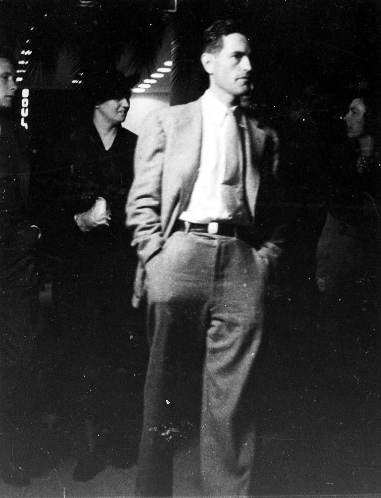 A vintage black and white photograph of aviation engineer Donald A. Hall, designer of the Sprit of St Louis exiting the theater in San Diego, California.